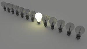 Graphic of row of light bulbs with one lit, representing SEO coding done right and website being notice by search engines.
